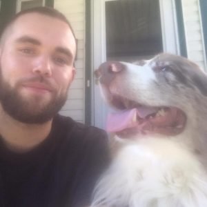 Owner of landscape company with beautiful white dog.