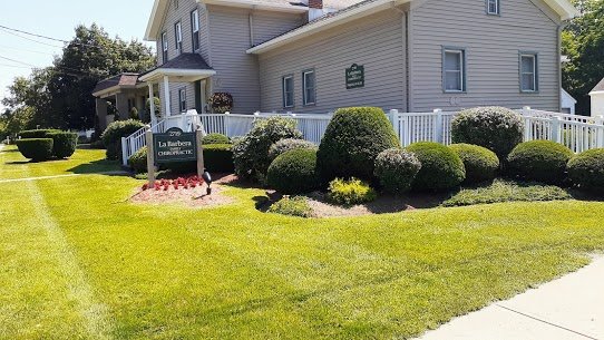 Residential and Commercial Landscape Service Maintaned landscape mulch bed, shrubs at Utica commercial lawn.