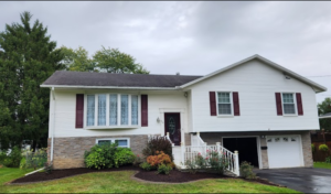 Two story ranch home with two stall attached garage and new landscaping bed.