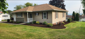 Refurbished Landscape bed with brown mulch and newly planted shrubs New Hartford, NY